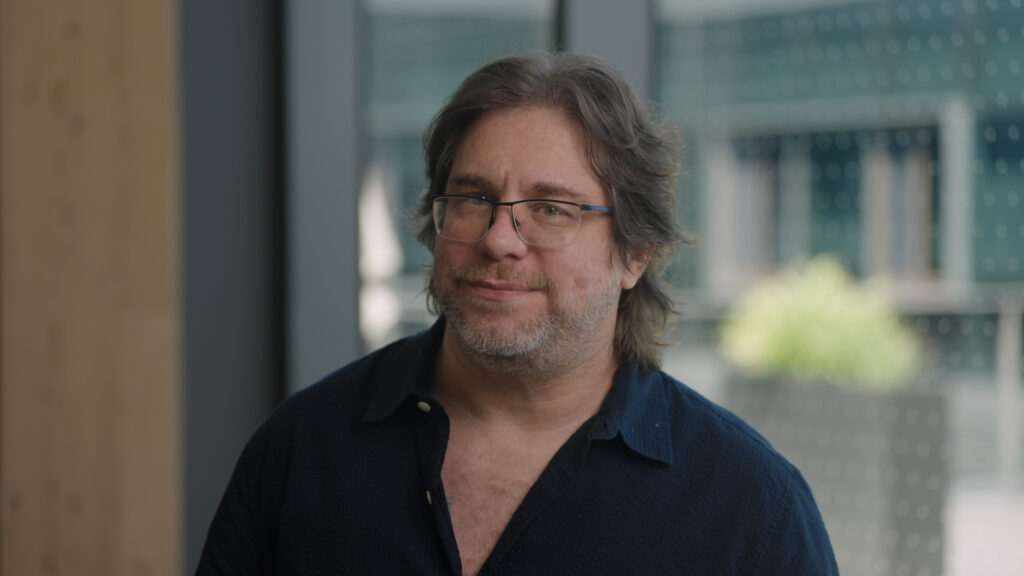 A man wearing glasses and a blue shirt