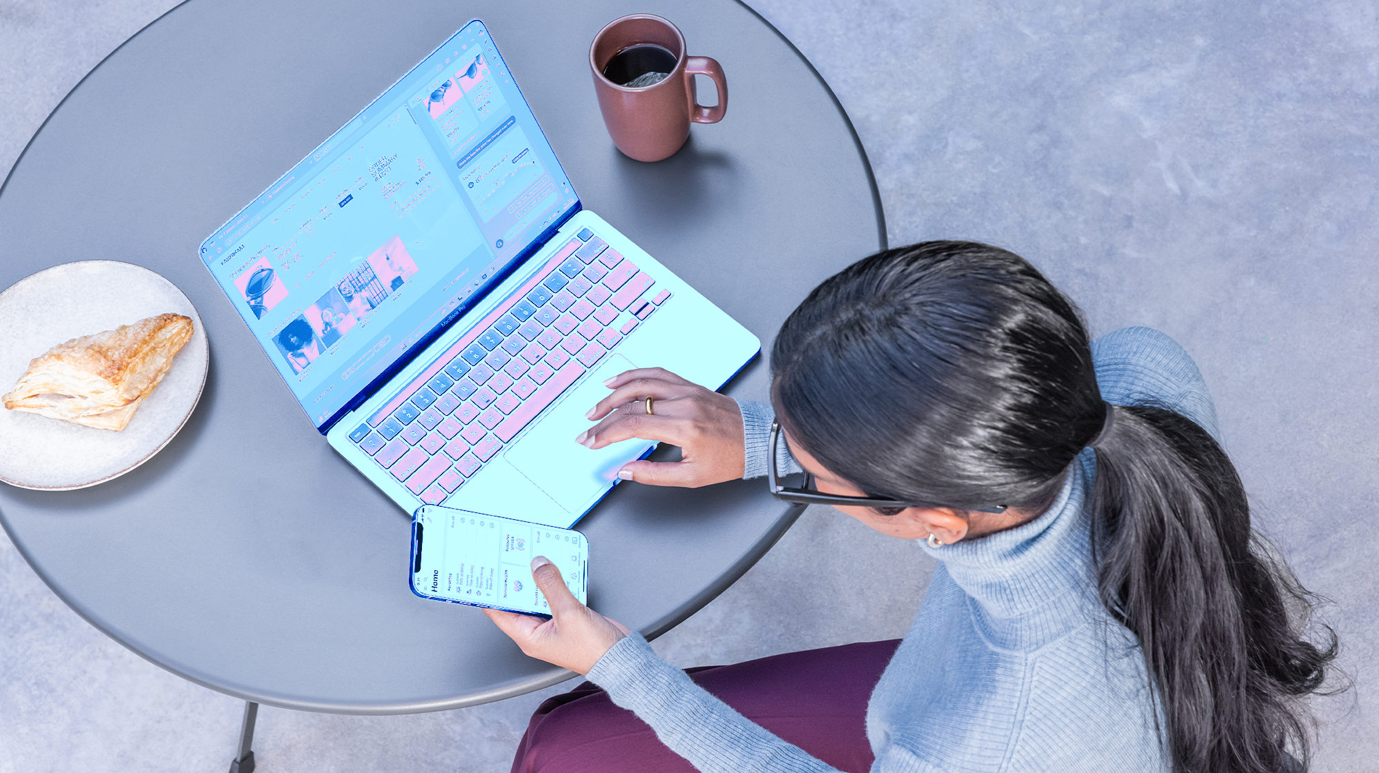 A woman sitting at a table using a laptop