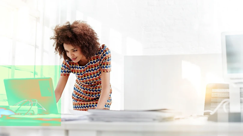 A woman standing in front of a computer