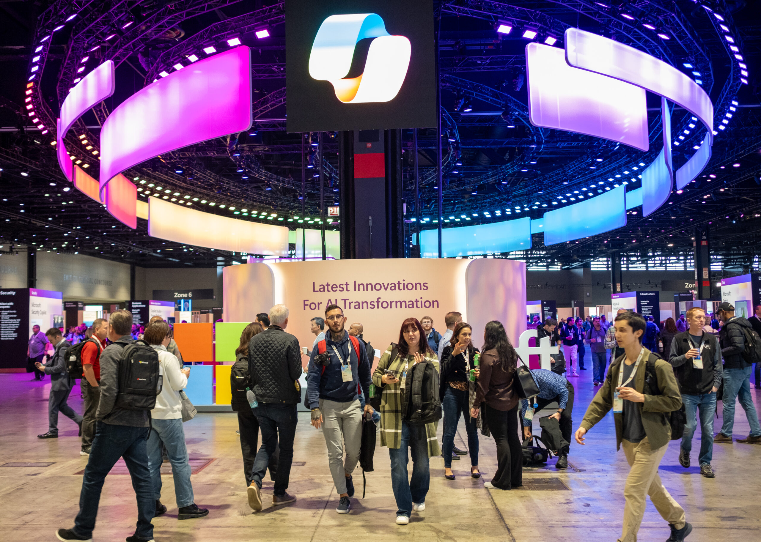A group of people walking in a large room