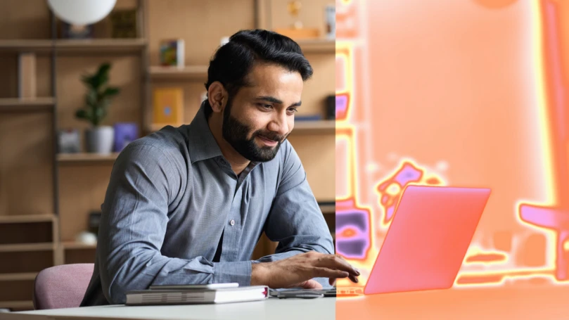 A man sitting at a desk with a laptop