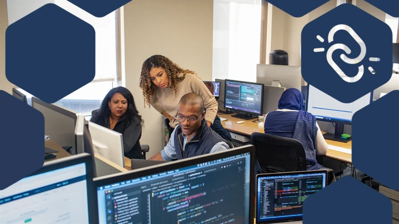 Developer manager collaborates with developer colleague in developer work space.