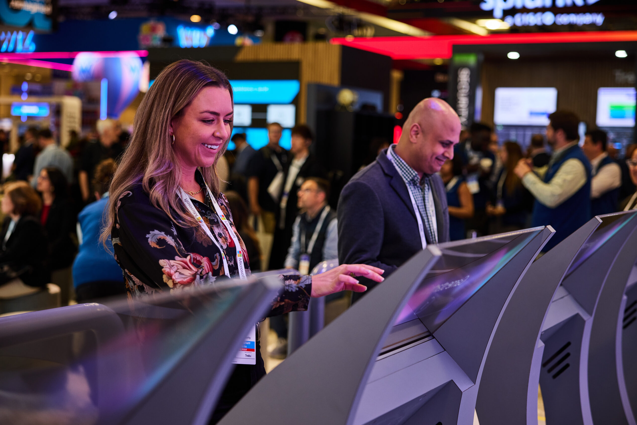 People interacting with touch screen at conference.