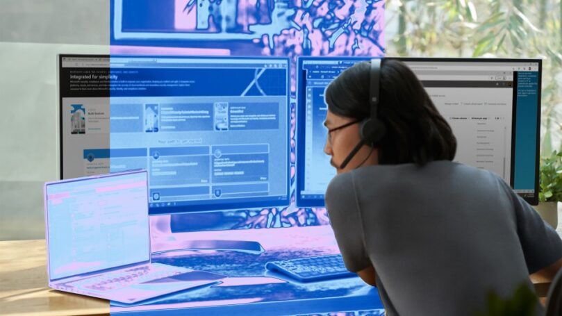 A security practitioner sits at a computer.