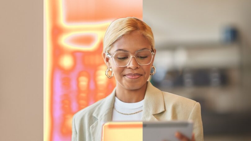 A woman holds a tablet computer.