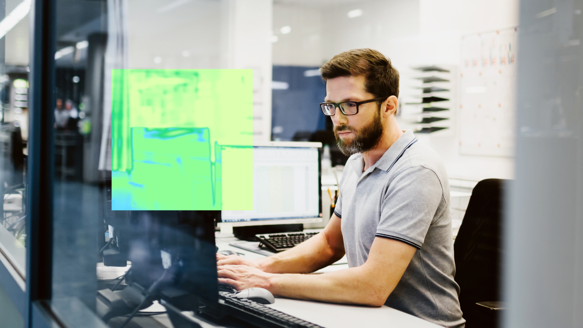 A security practitioner works at a computer.
