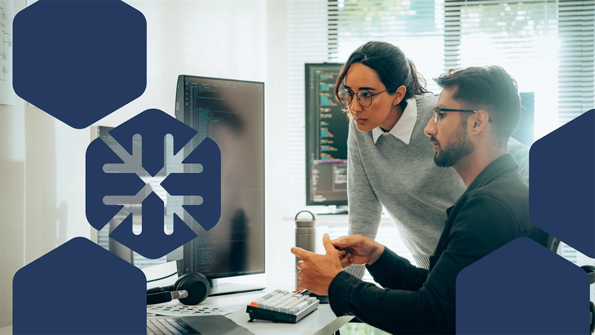 Photo of two coworkers looking at a computer screens, with the threat actor icon for Blizzard actors in overlay