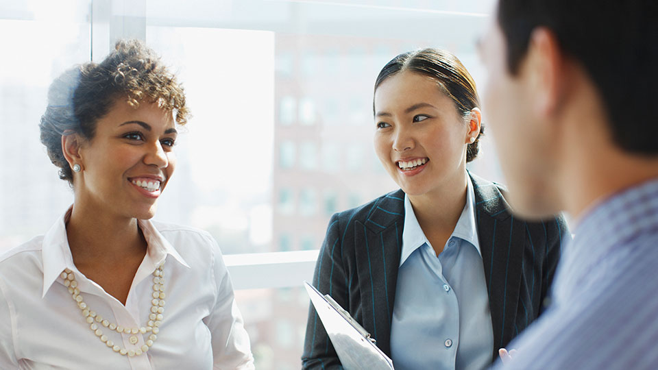 Smiling coworkers in conversation