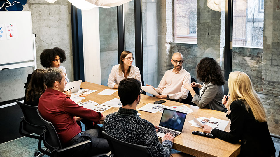 A group of coworkers around a conference table