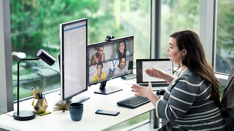 A woman speaks in a video call with multiple attendees