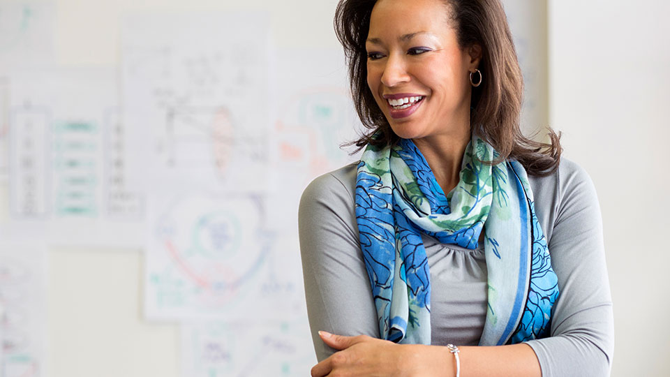 A woman smiling in an office environment