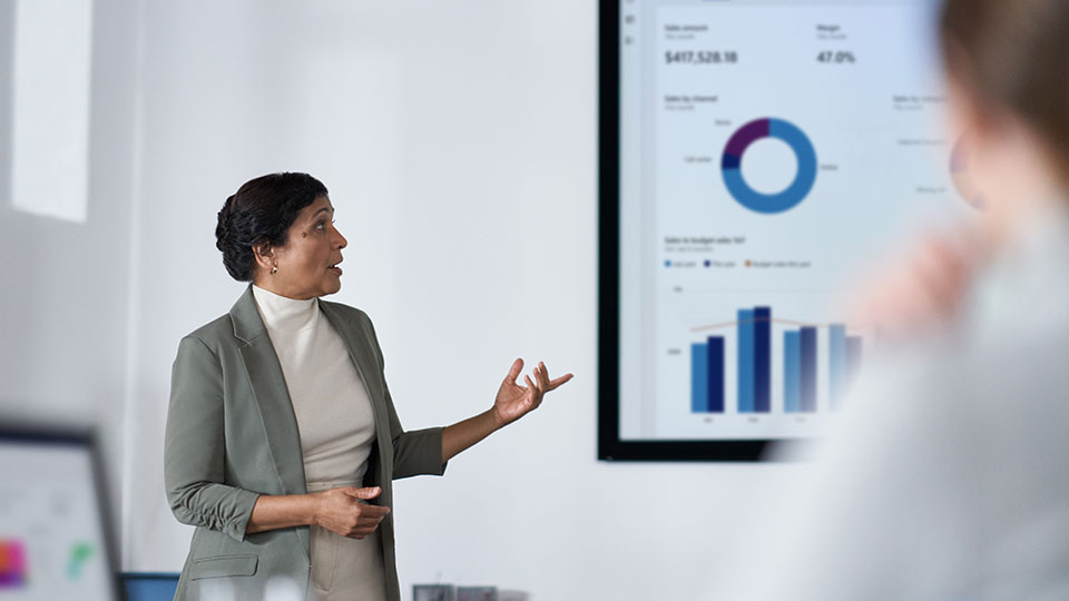 A woman gives a presentation in an office environment