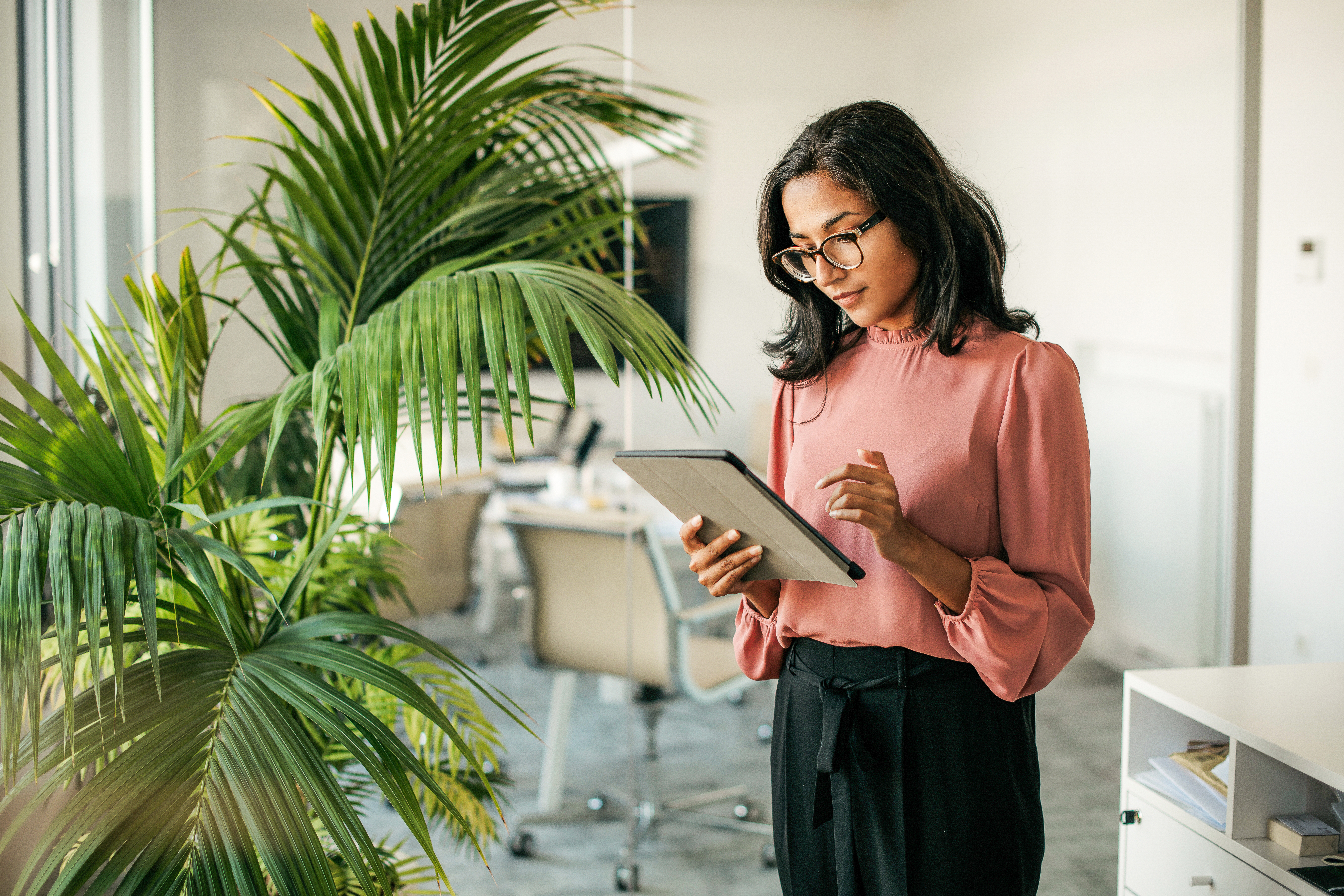 Positon AI featured image: Young Indian Businesswoman Using Digital Tablet in Office