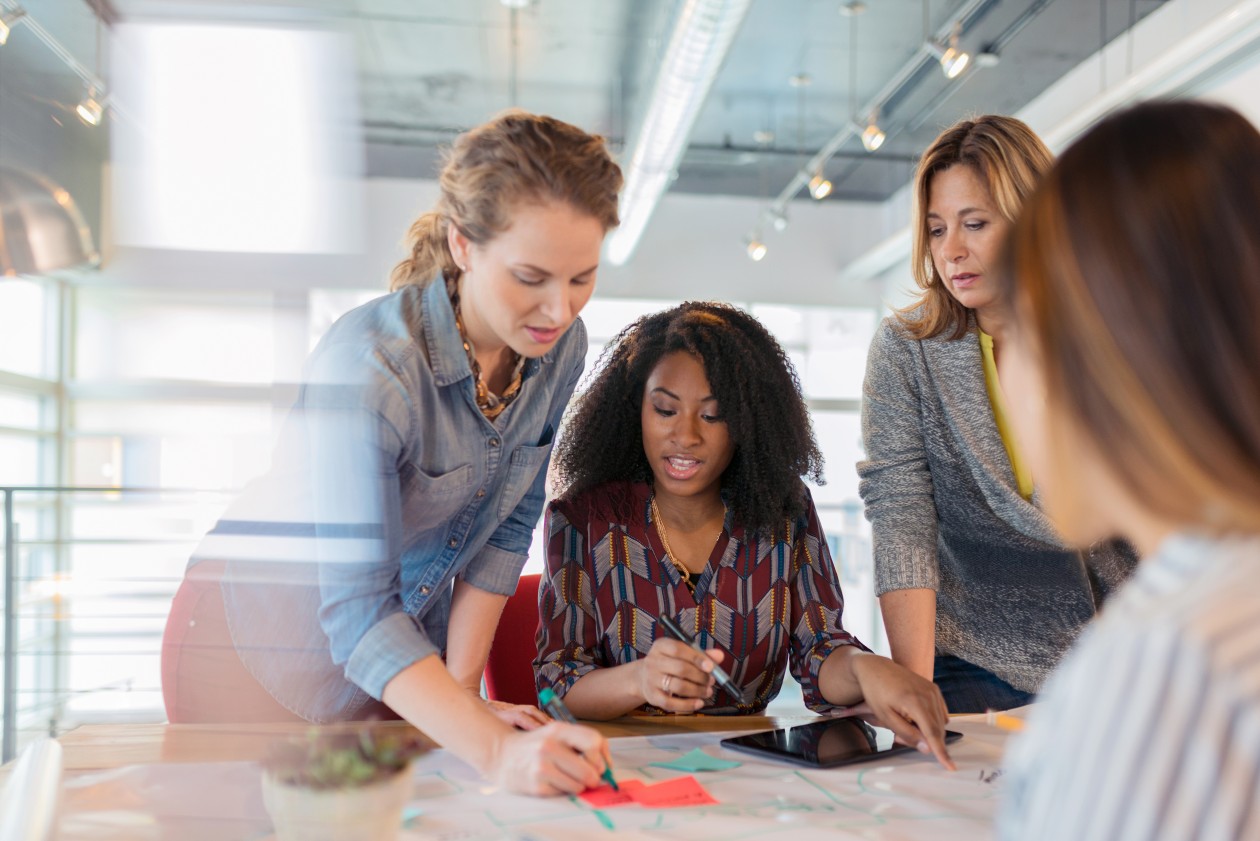 Group of four women collaborating