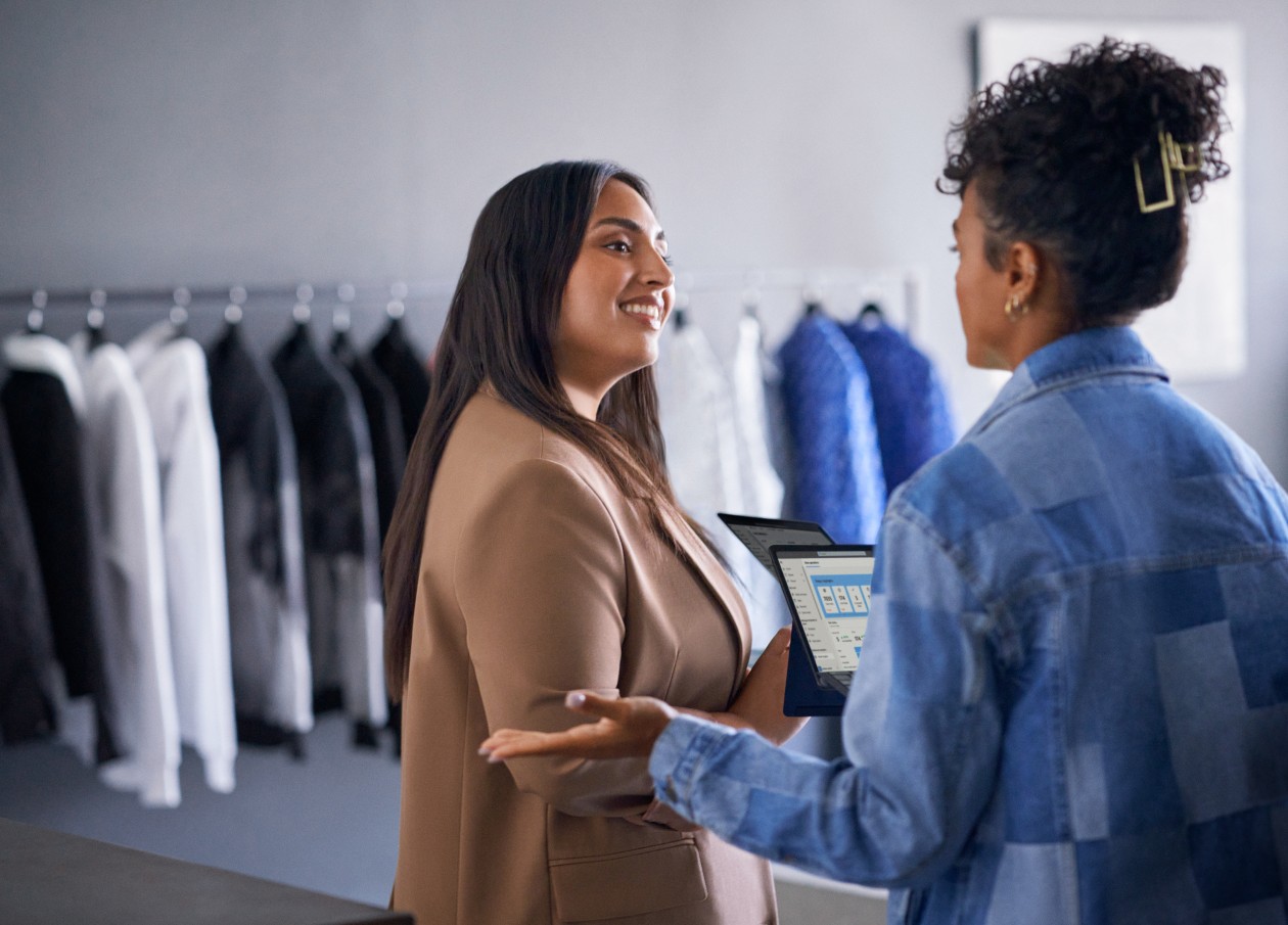 Azure solution powering retail business. Retail business operations manager reviewing real time data with employee.