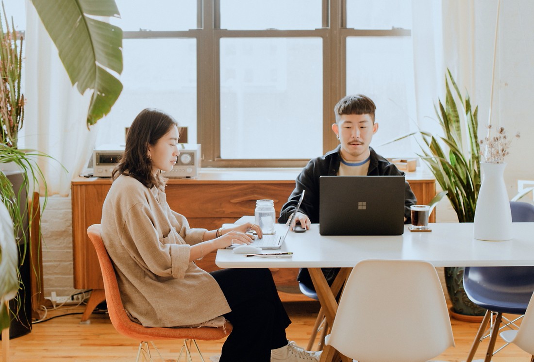 Two people working at a table