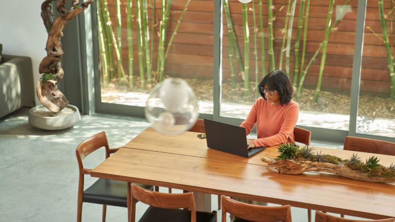 Overhead view of business decision maker working from home on a laptop
