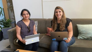 Carini and Chebiyam smile for the camera in a photo taken in an office in a Microsoft building.