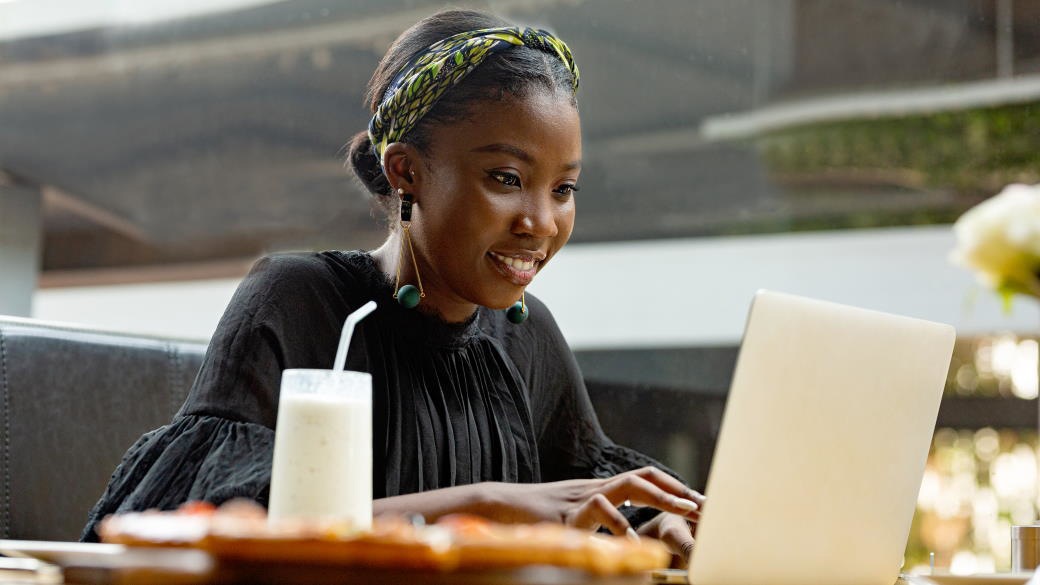 A Microsoft employee works at her laptop in a Microsoft open space.