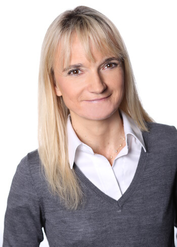 D’Hers smiles in a portrait photo. 