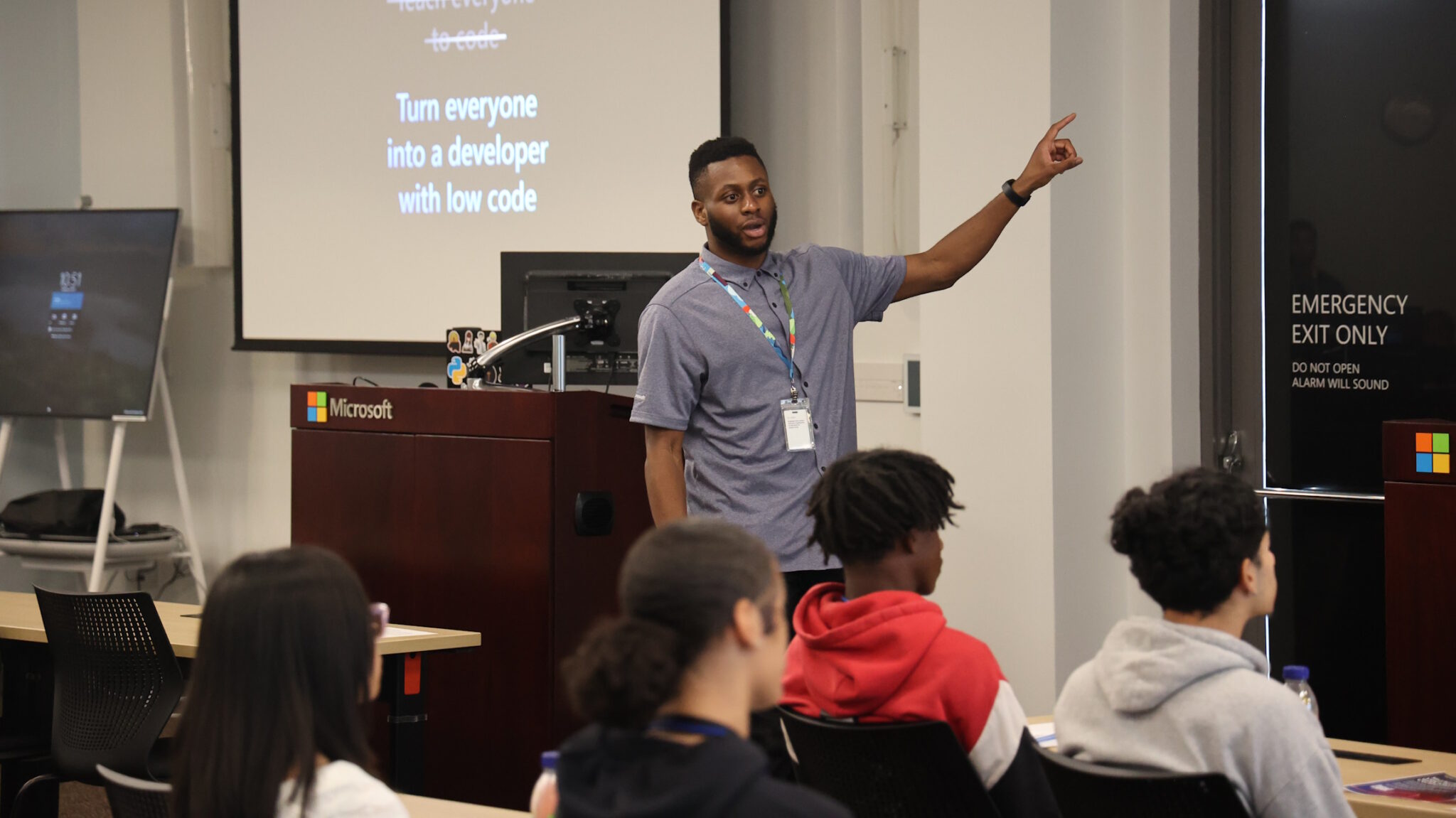 Akinyemi gestures as he talks to a room of students visiting Microsoft.