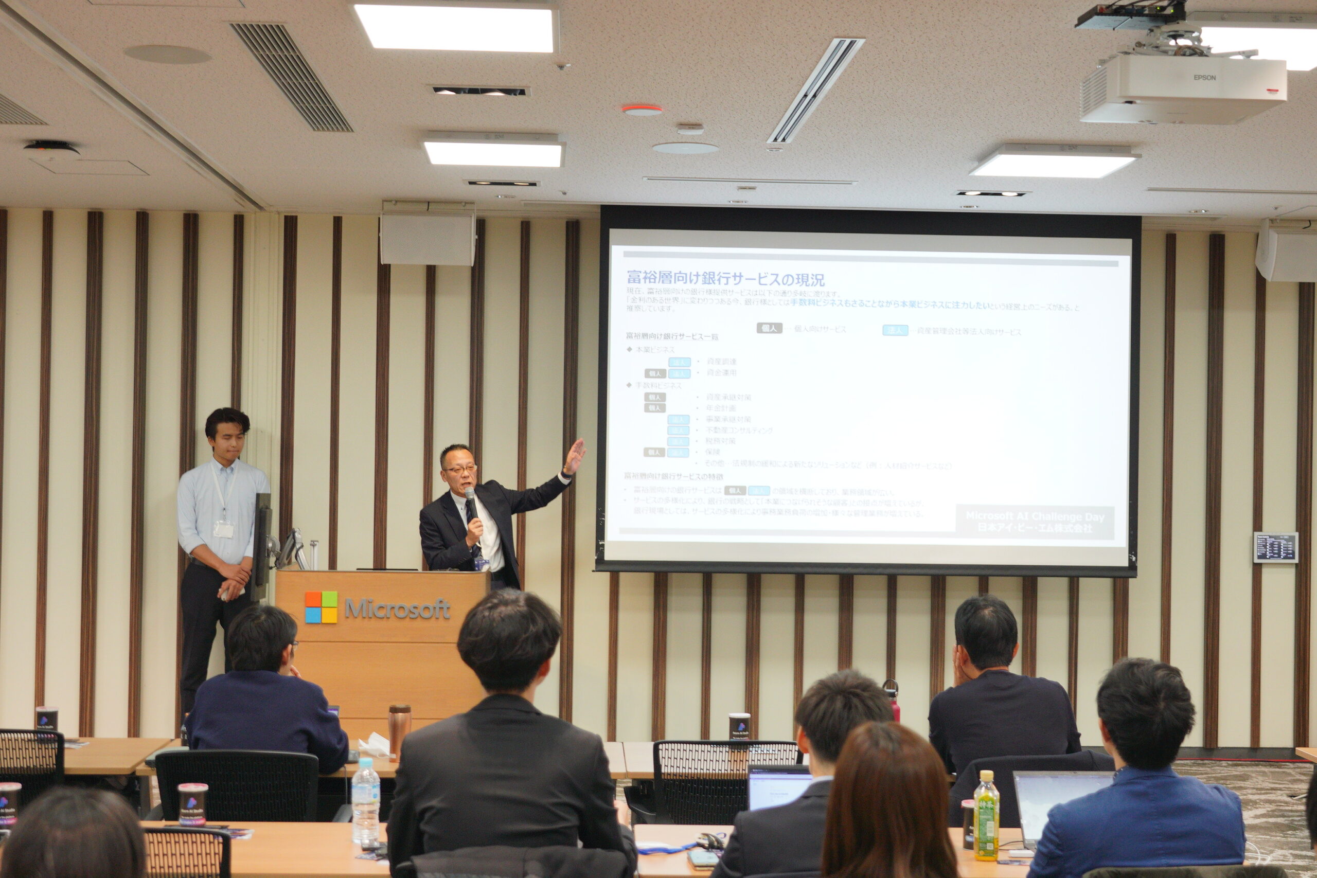 A man standing in front of a screen