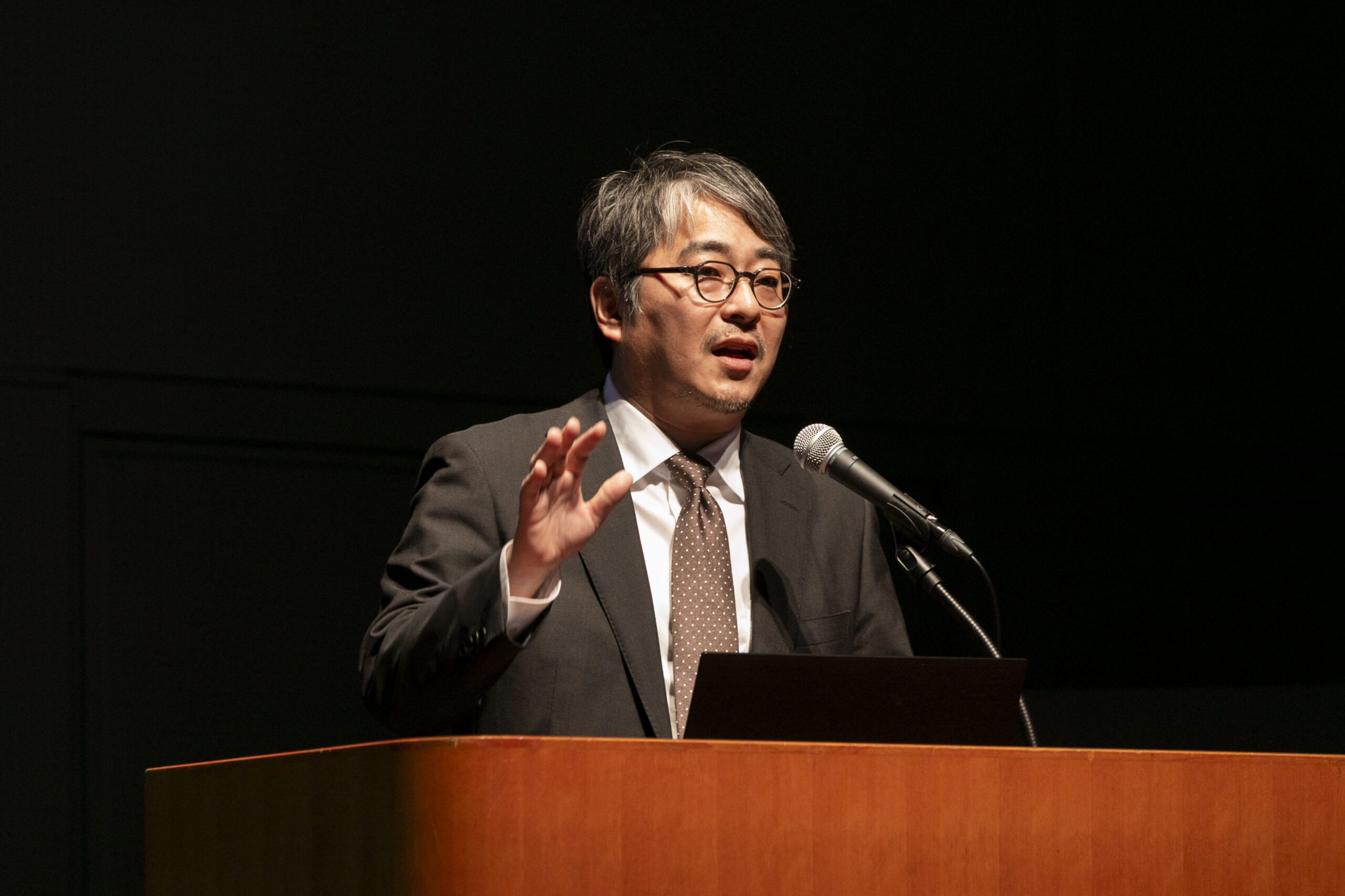 A man standing at a podium with a microphone