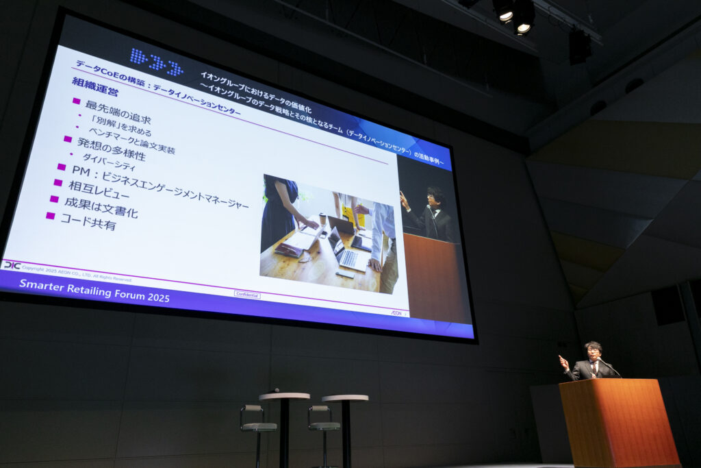 A man standing in front of a screen