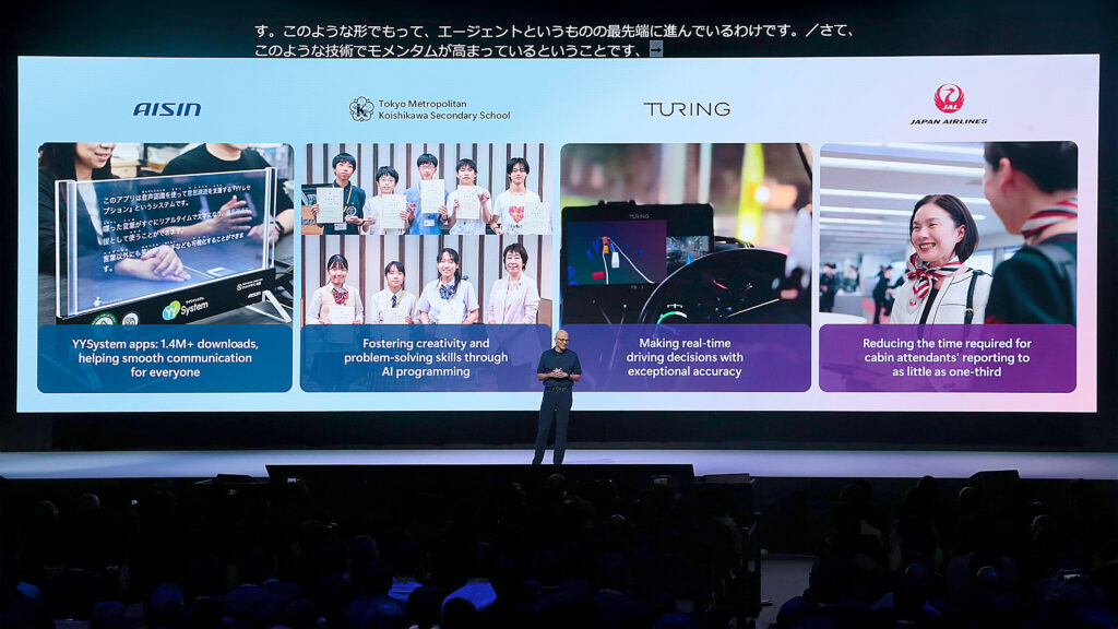 A man standing in front of a large screen