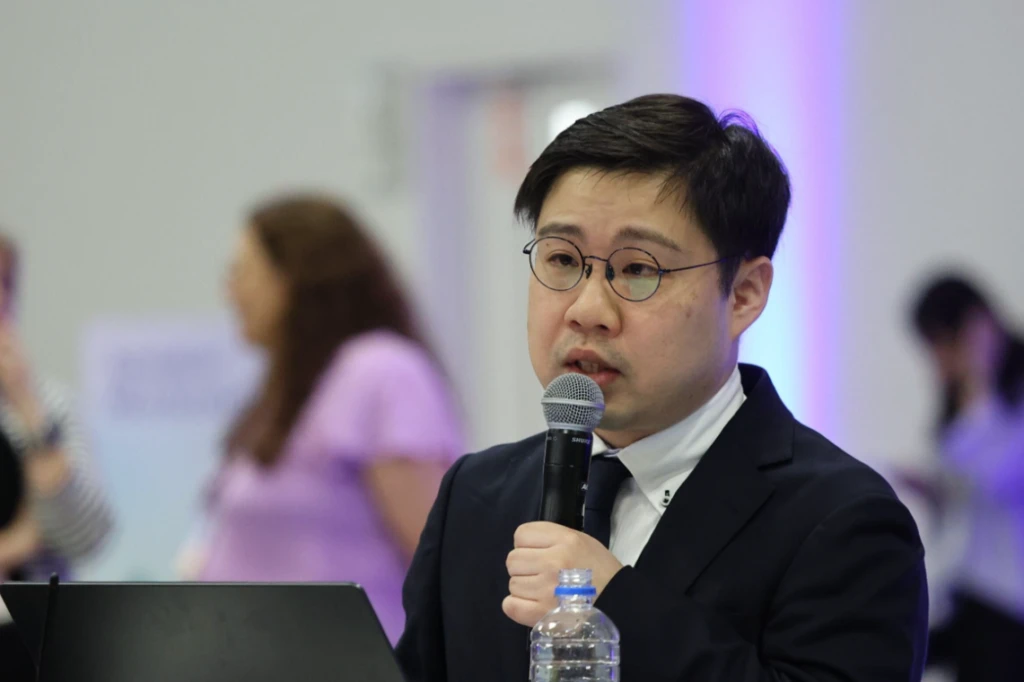 A man in a suit holding a microphone