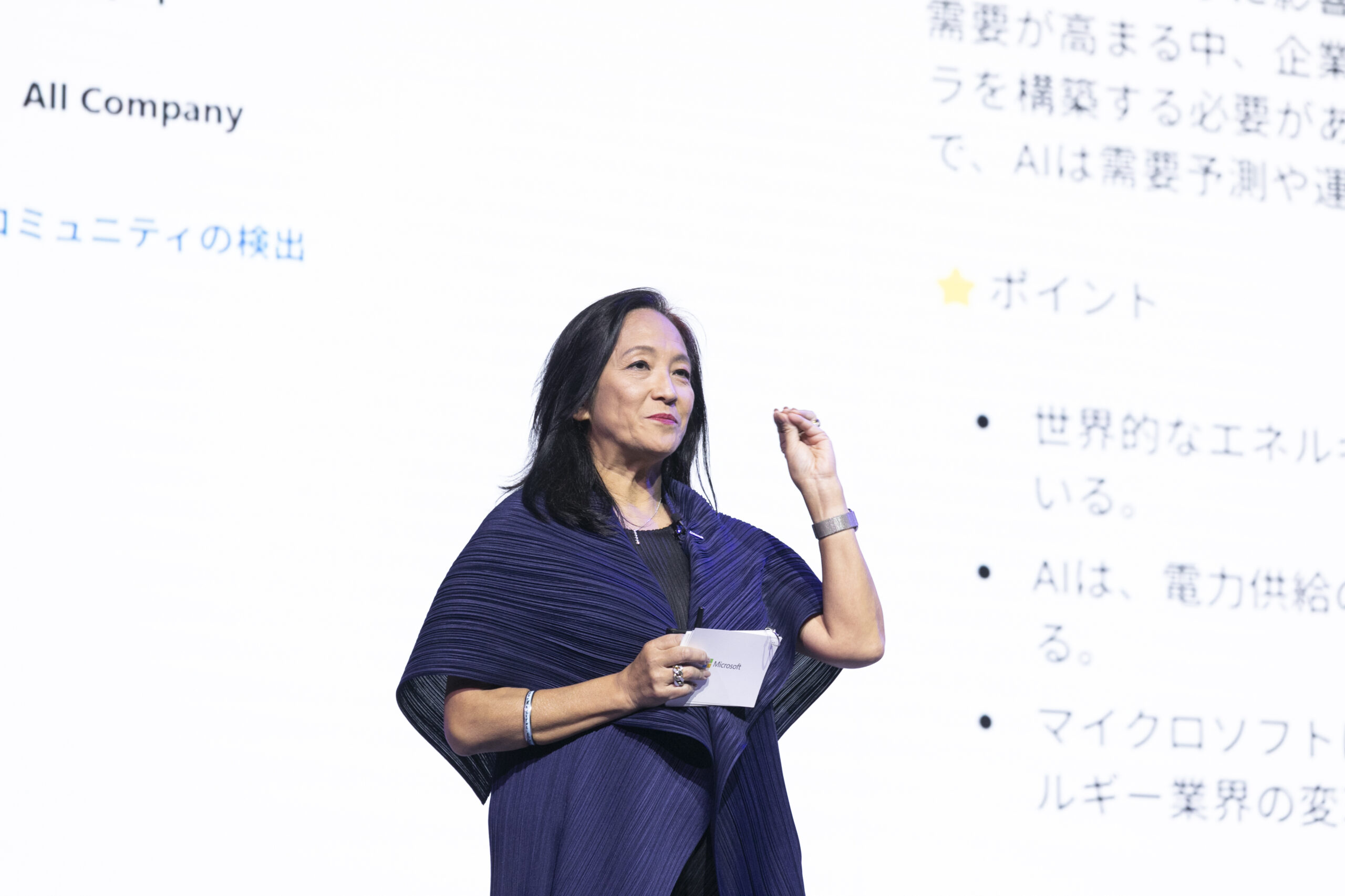 A woman standing in front of a white board