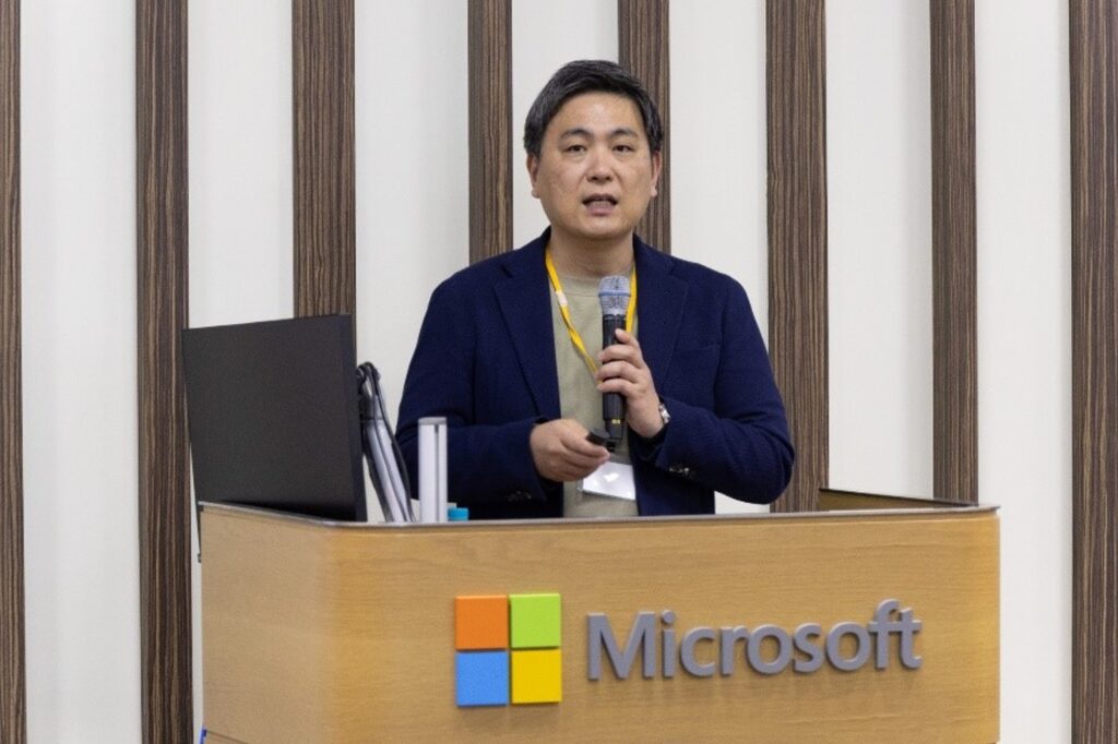 A man standing at a podium holding a microphone