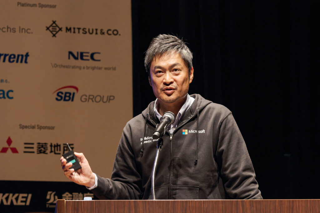 A man standing at a podium with a microphone