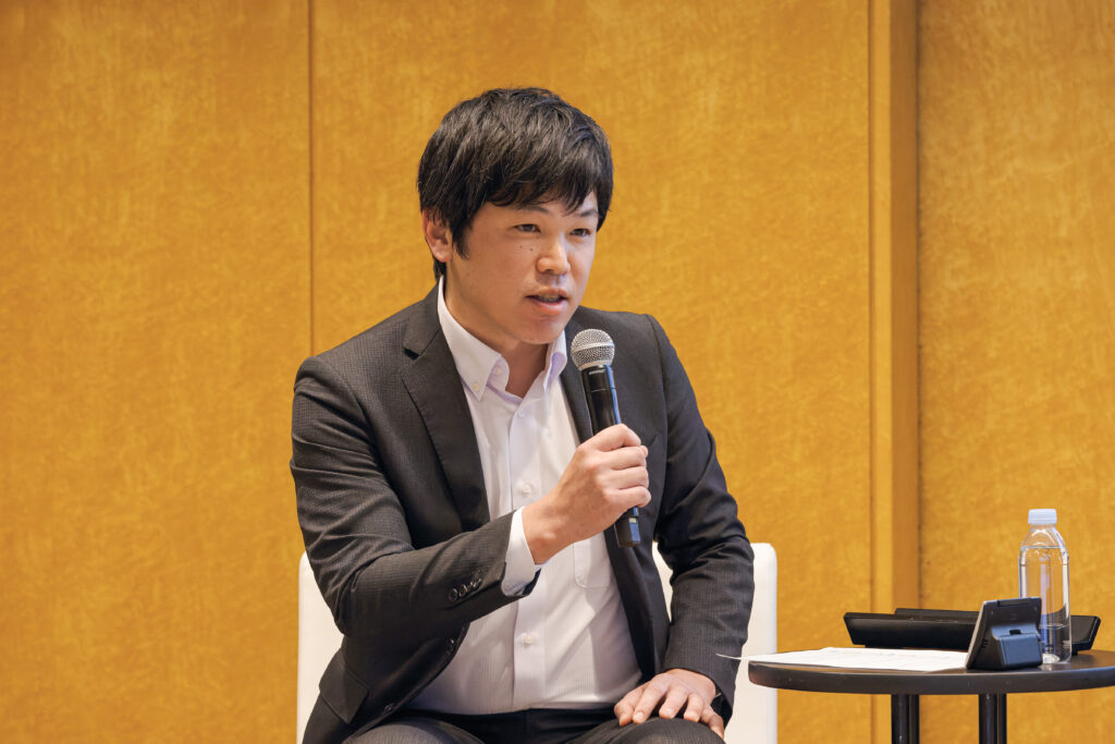 A man in a suit holding a microphone