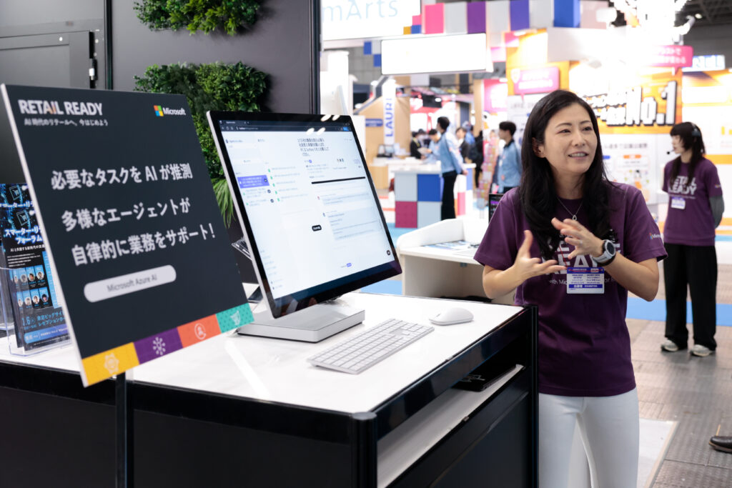A woman standing in front of a computer