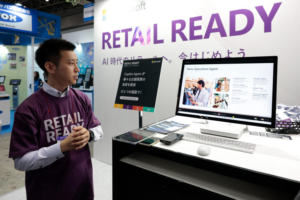 A man standing next to a computer