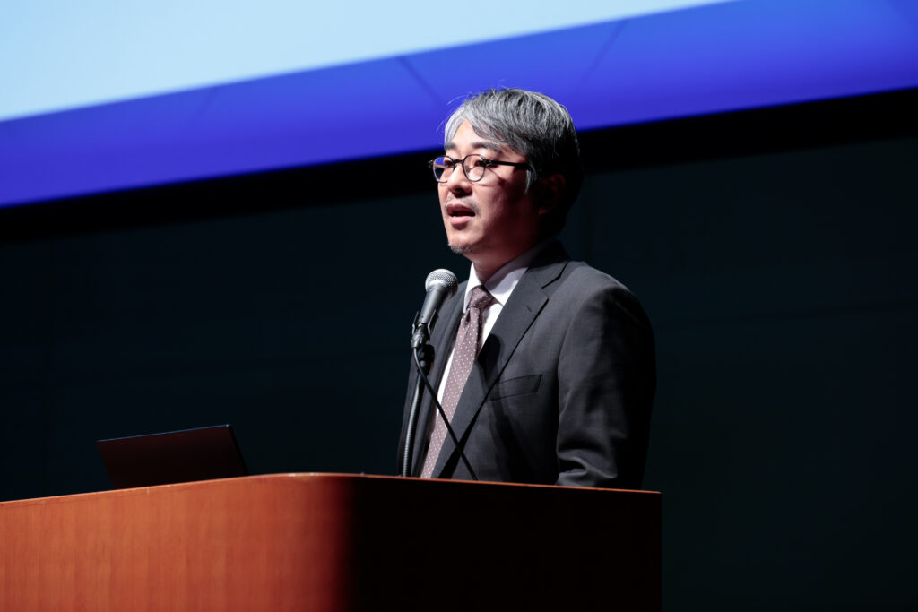 A man standing at a podium with a microphone