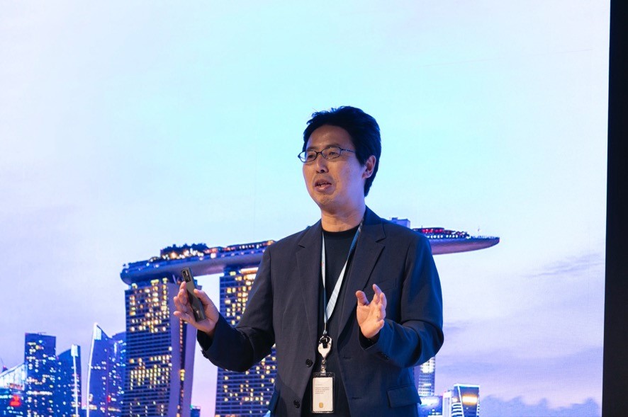 A man in a suit holding a phone in front of a city