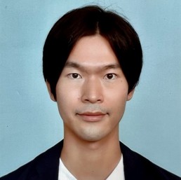 Head-and-shoulders portrait of a person with dark hair against a plain background.